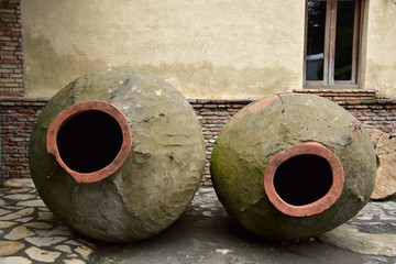 Barrels for wine production in an old, traditional way. - obrazy, fototapety, plakaty