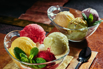 Sorbet in a transparent pial on copper plates close-up. colorful balls of sorbet. series of photos