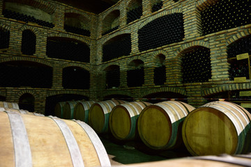 Cellars with barrels for wine production in an old, traditional way. - obrazy, fototapety, plakaty
