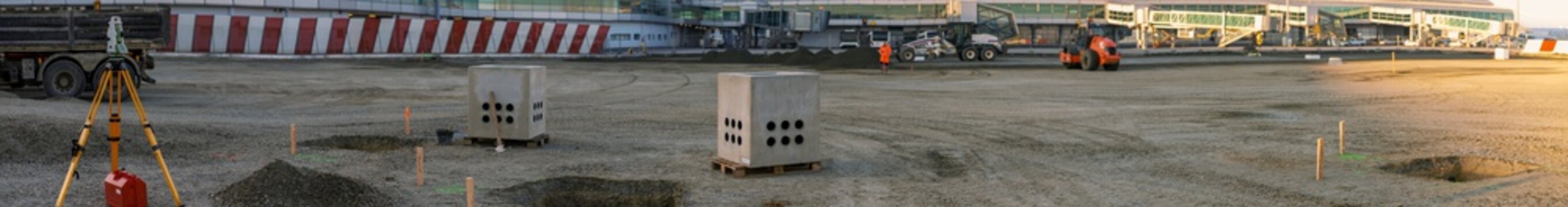 Panoramic view of surveyor equipment (theodolit or total positioning station) on the construction site of the building or aiport