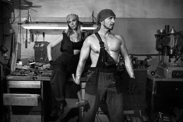 Fototapeta na wymiar Man and a beautiful woman in a metalwork shop.