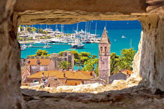 Trogir church and turquoise waterfront view through stone window