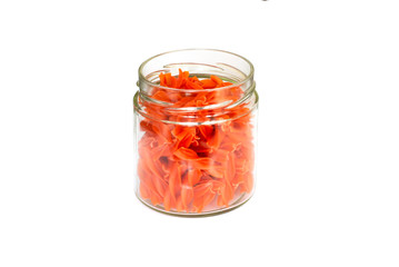 Red lentils pasta in glass jar, isolated