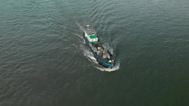Aerial view of bilge ship/boat sailing over river (Waal) in The Netherlands during fall 2018