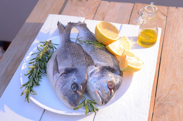 dorado fish on a black plate and wooden table