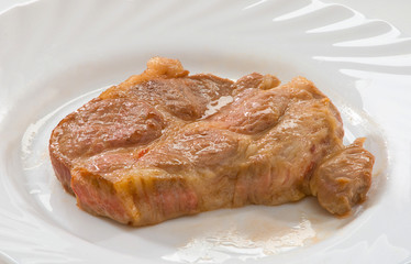Стейк из свинины на тарелке Pork steak on a plate