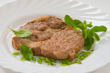 Стейк из свинины на тарелке Pork steak on a plate