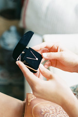 Woman holding jewelry box with necklace