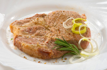 Стейк из свинины на тарелке Pork steak on a plate