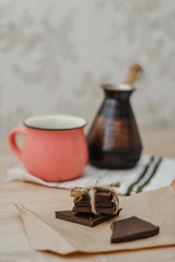 Homemade chocolate, cup of coffee and a turkish coffee pot.