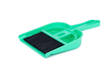 green dustpan scoop and brush isolated on the white