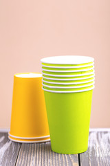 Fototapeta premium Recycling bright and colorful paper cups on wooden table