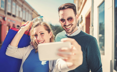 Beautiful young couple enjoying in shopping. Consumerism, fashion, lifestyle concept