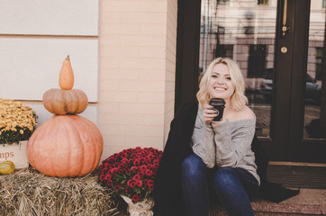 beautiful woman in black jacket drinking coffee