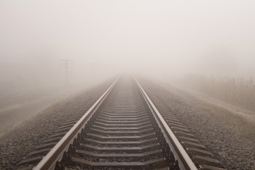 Fototapeta na wymiar Foggy railway landscape. Horizontal photo.