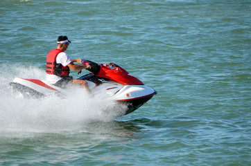 Man speeding on a jet ski on the Florida Intra-Coastal; Waterway