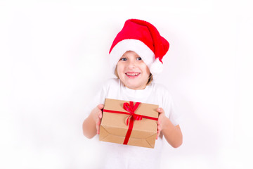 Happy boy in Santa red hat holding Christmas gift in hand. Christmas concept.