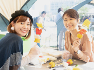 young asian woman enjoying BBQ