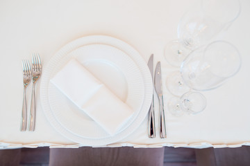 White wedding table decor. Beautiful table set for an event party or wedding reception. Top view