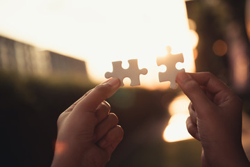 Closeup of woman hands joining pieces of jigsaw puzzle together.,Business solutions, success...