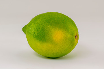 Fresh yellow-green lime on white background