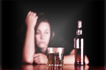 Drunk Woman At Bar Counter with a Bottle and a Glass of Whisky