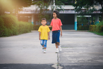 Blur background Brothers and sisters walk hand in hand