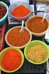 Colorful ground herbs and spices for sale at a market in rural Laos