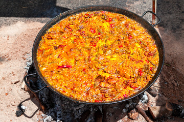 Seafood Paella. The national Spanish dish of paella in a large skillet is cooked on an open fire, at the stake.