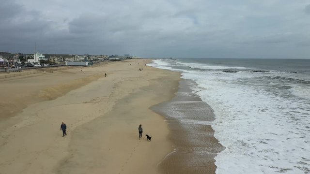 Drone flies backwards and films the beach of Belmar.