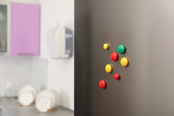 Fototapeta na wymiar Many colorful magnets on refrigerator door indoors