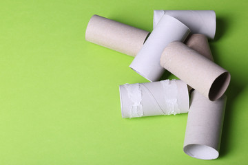Empty toilet paper rolls and space for text on color background