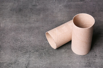 Empty toilet paper rolls and space for text on gray background