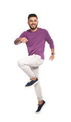 Fototapeta premium Handsome young man jumping on white background