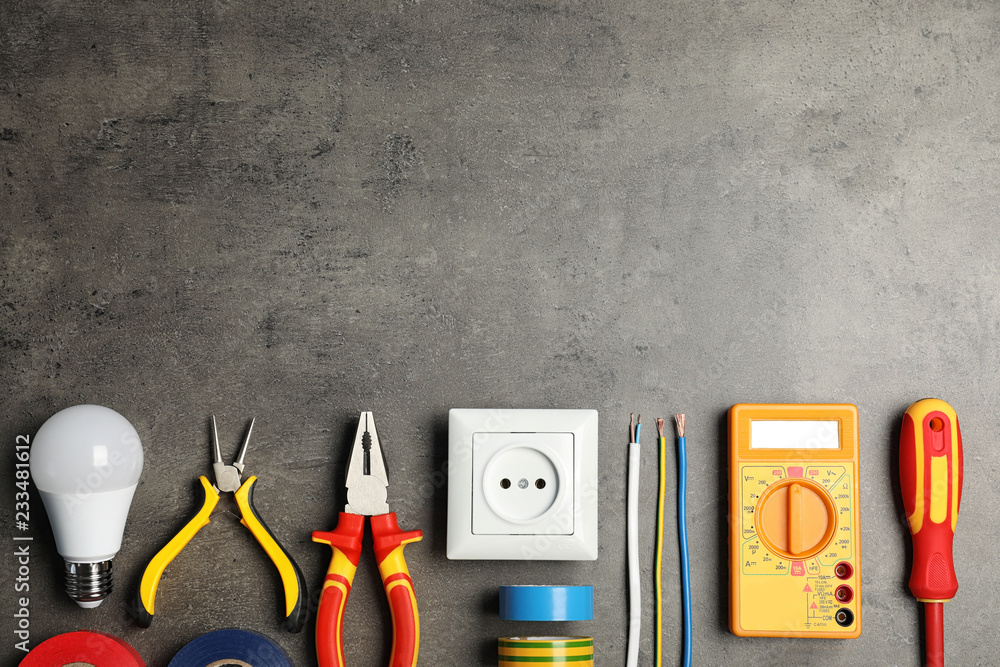 Poster Electrician's tools and space for text on gray background, flat lay