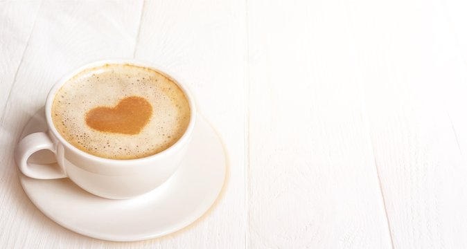 Cup of coffee on wooden background