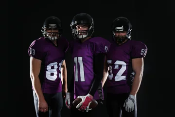 Foto op Canvas American football players in uniform on dark background © New Africa