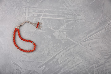 Muslim prayer beads and space for text on grey background, top view