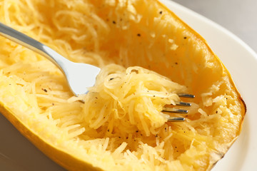 Plate with spaghetti squash and fork, closeup