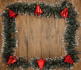 Christmas card with a fringe of branches of Christmas trees and festive toys on branches