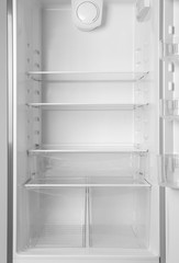 Fototapeta premium Modern open refrigerator with empty shelves, closeup