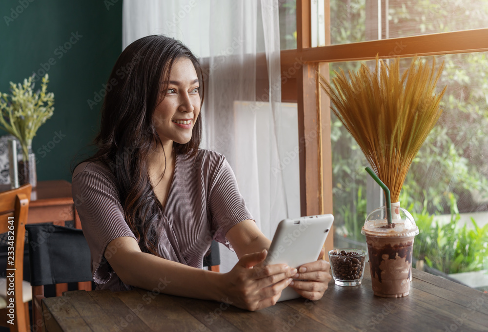 Sticker happy woman using tablet in café