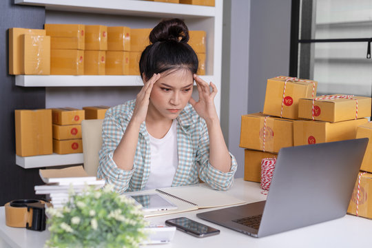 stressed entrepreneur woman and courier parcel box at home office