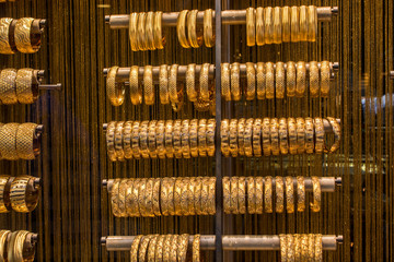 Shop display of dozens of golden bracelets