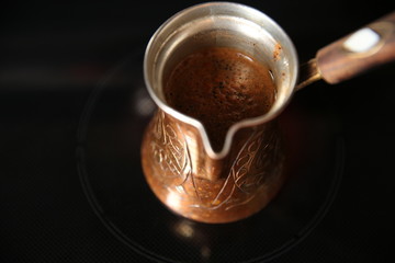 coffee in a turk on a black background