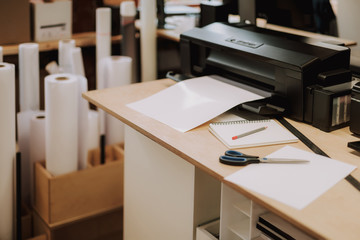 Office equipment, scissors, notebook with pencil, sheet of paper and ruler on wooden desk