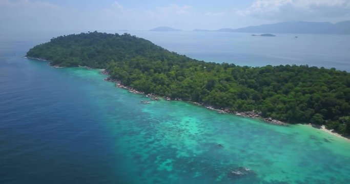 Colorful coral reef and turquoise sea panoramic view from high elevation aerial drone panning LR on Pattaya beach side of tropical island, Ko Lipe, Thailand. 4k 1.9:1 23.976fps Part 1 of 3