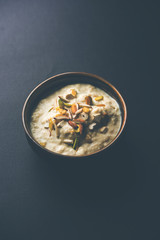 Sweet Rabdi or Lachha Rabri or basundi, made with pure milk garnished with dry fruits. Served in a bowl over moody background. Selective focus