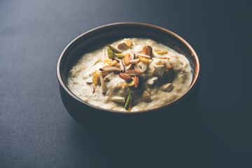Sweet Rabdi or Lachha Rabri or basundi, made with pure milk garnished with dry fruits. Served in a bowl over moody background. Selective focus