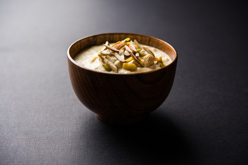Sweet Rabdi or Lachha Rabri or basundi, made with pure milk garnished with dry fruits. Served in a bowl over moody background. Selective focus